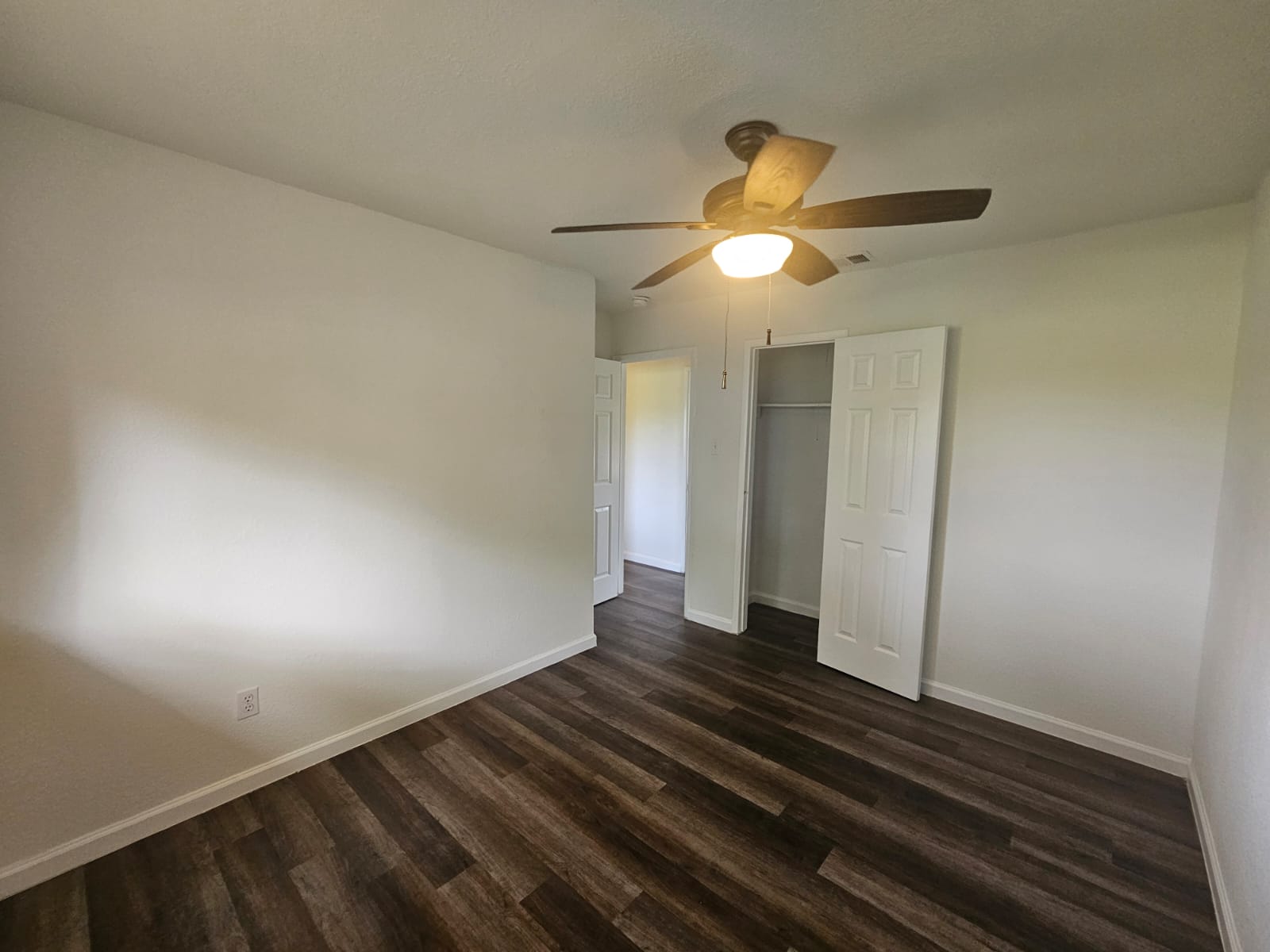 1401 Trinity Street Lockhart, TX 78644 - Photo 9 of 31 Room featuring wood-finish flooring, a ceiling fan with integrated lighting, and white baseboards