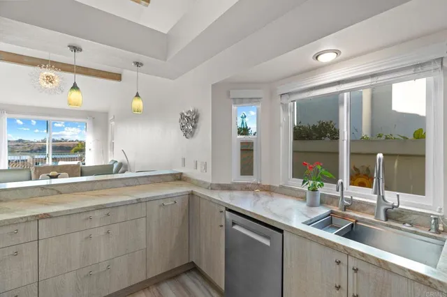 a kitchen with a sink and large window
