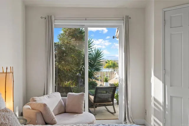 a balcony with furniture and a potted plant