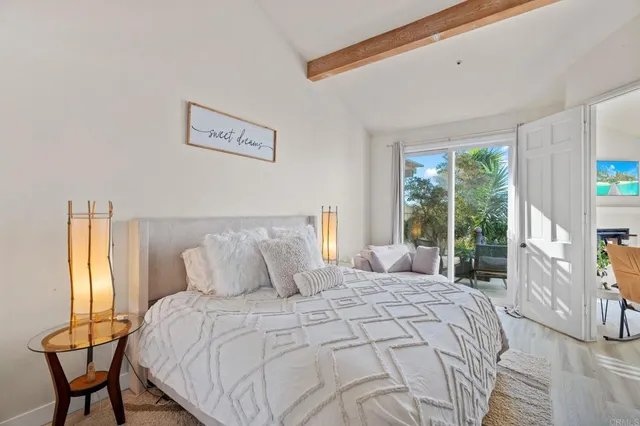 a bedroom with a bed and a lamp next to a window