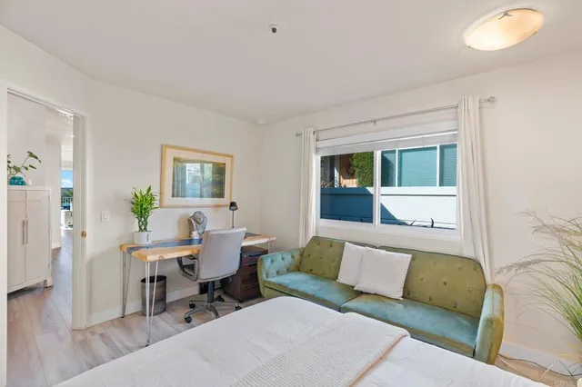 a living room with furniture and a potted plant