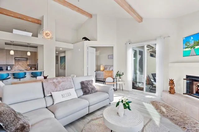 a living room with furniture dining area and a fireplace