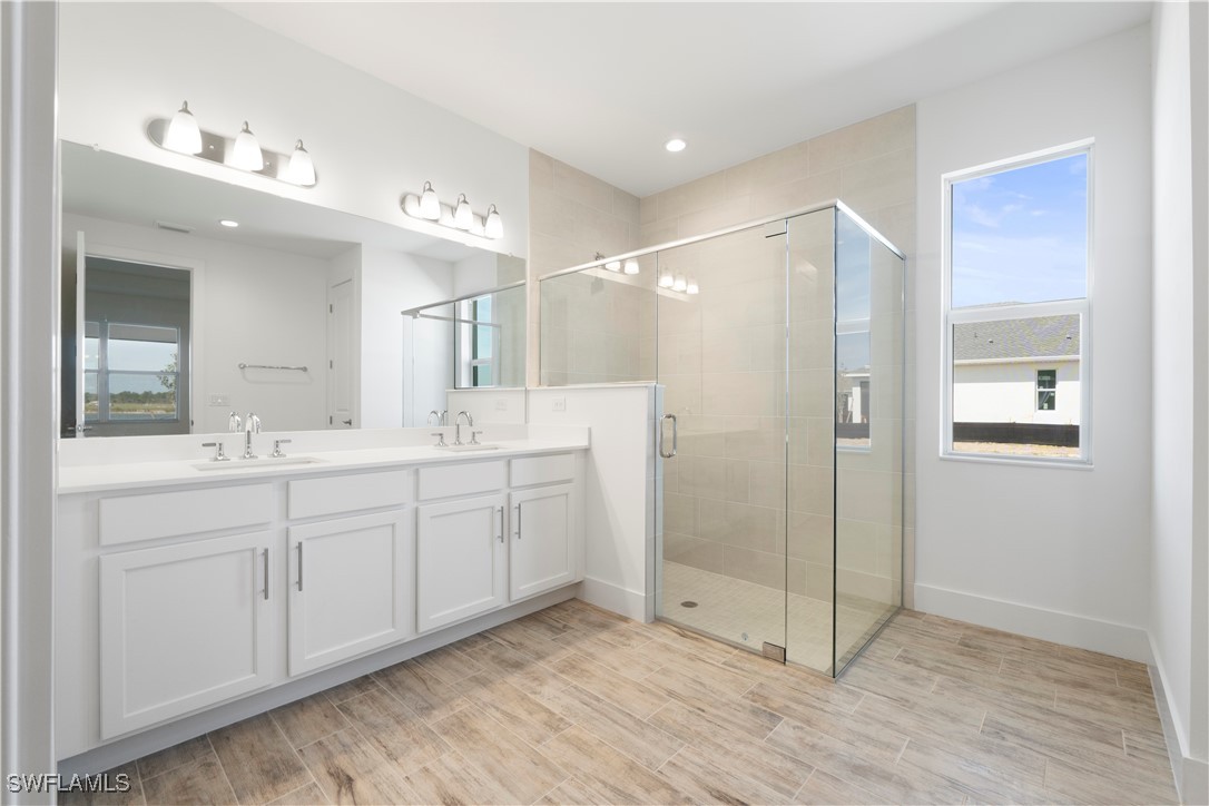 16245 Wax Myrtle Street Punta Gorda, FL 33982 - Photo 17 of 22 a bathroom with a double vanity sink shower and a mirror