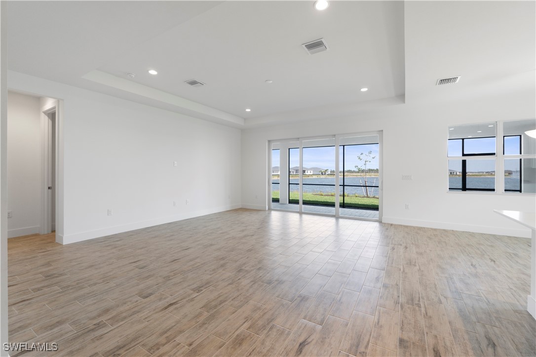 16245 Wax Myrtle Street Punta Gorda, FL 33982 - Photo 20 of 22 a view of empty room with wooden floor and fan