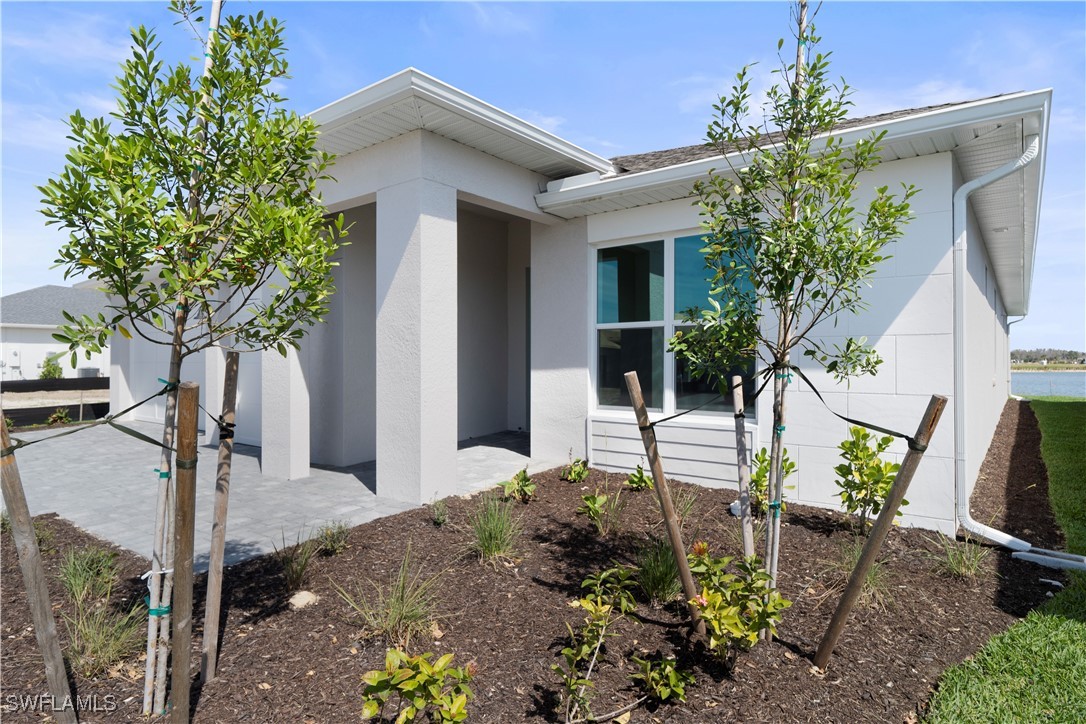 16245 Wax Myrtle Street Punta Gorda, FL 33982 - Photo 2 of 22 a front view of a house with garden