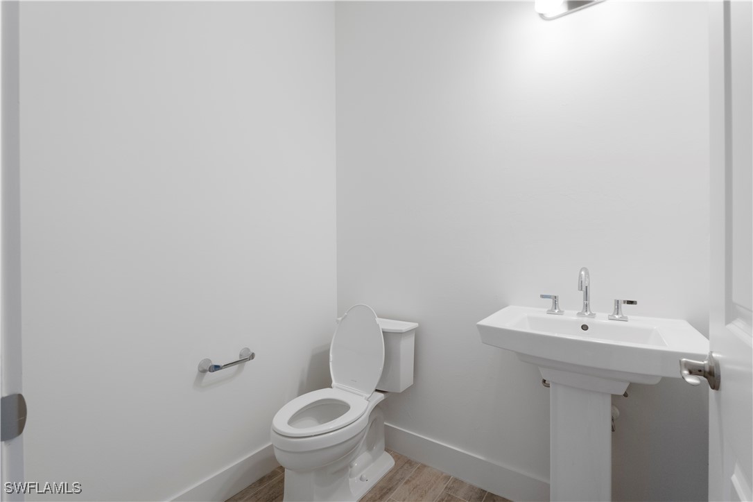 16245 Wax Myrtle Street Punta Gorda, FL 33982 - Photo 22 of 22 a bathroom with a sink toilet and a mirror
