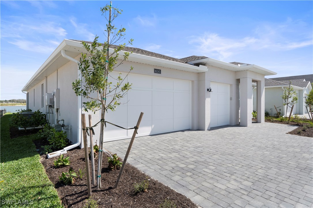 16245 Wax Myrtle Street Punta Gorda, FL 33982 - Photo 3 of 22 a front view of a house with garden