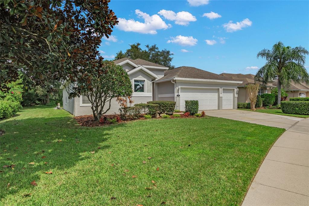 9015 Laurel Ridge Drive Mount Dora, FL 32757 - Photo 1 of 1 a front view of a house with a garden