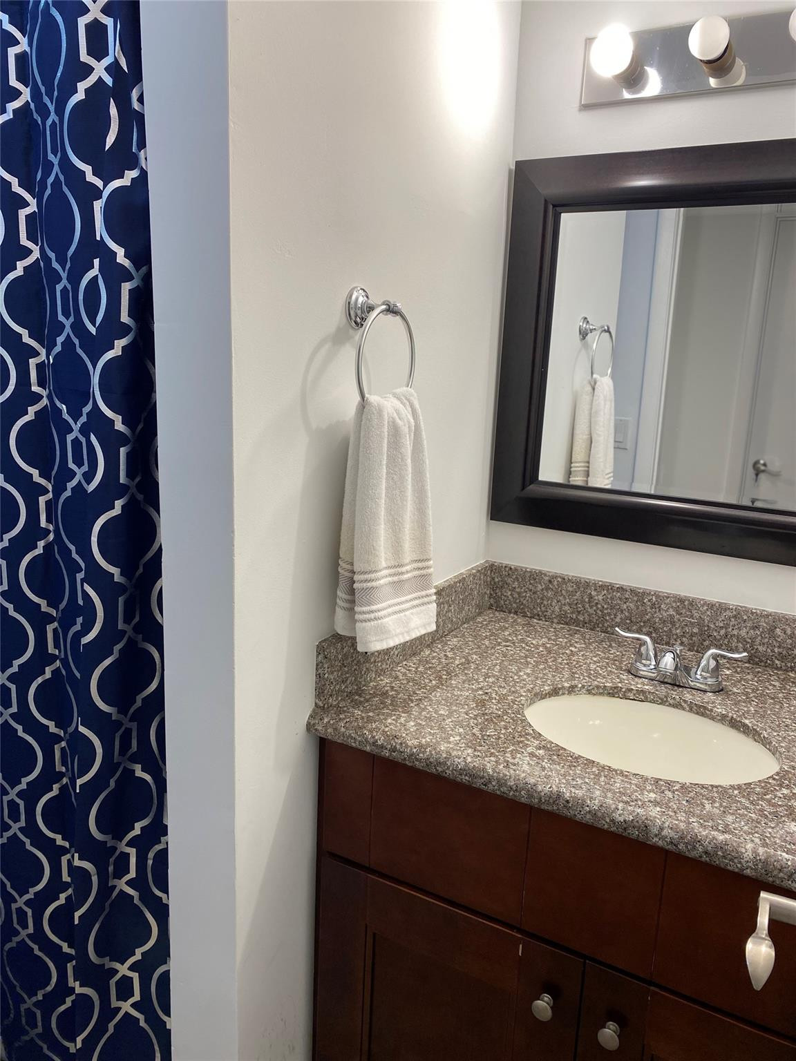 1247 Southwest 46th Avenue, Unit 1301 Pompano Beach, FL 33069 - Photo 17 of 22 a bathroom with a granite countertop sink and a mirror