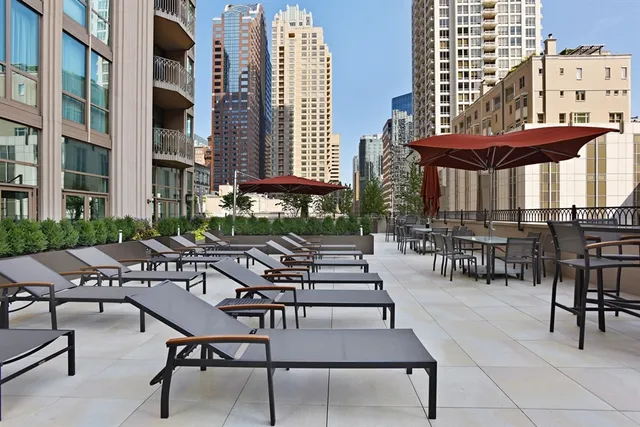 a view of a patio with chairs and tables