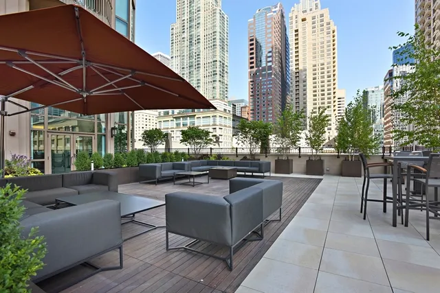 a view of a patio with couches and table under an umbrella