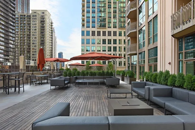 a view of a patio with couches table and chairs and potted plants