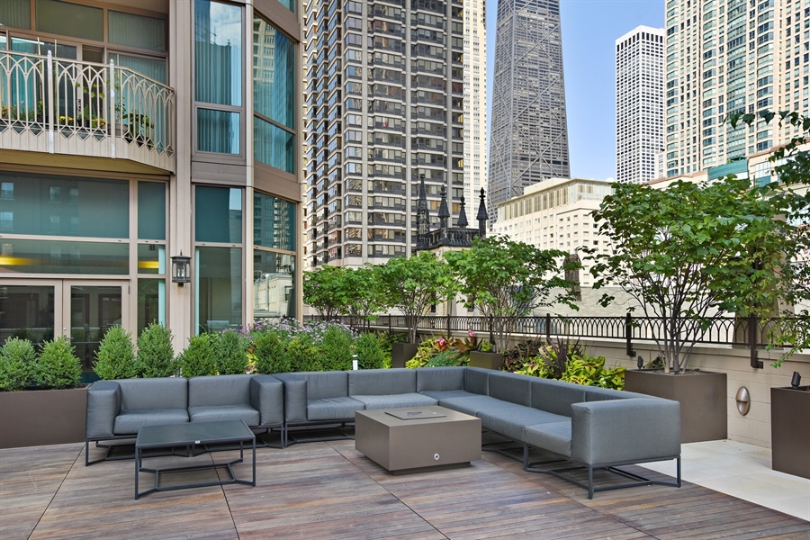 21 East Huron Street, Unit 1407 Chicago, IL 60611 - Photo 22 of 23 a view of a patio with couches and a potted plant on a table