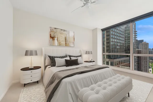 a spacious bedroom with a bed and a large window