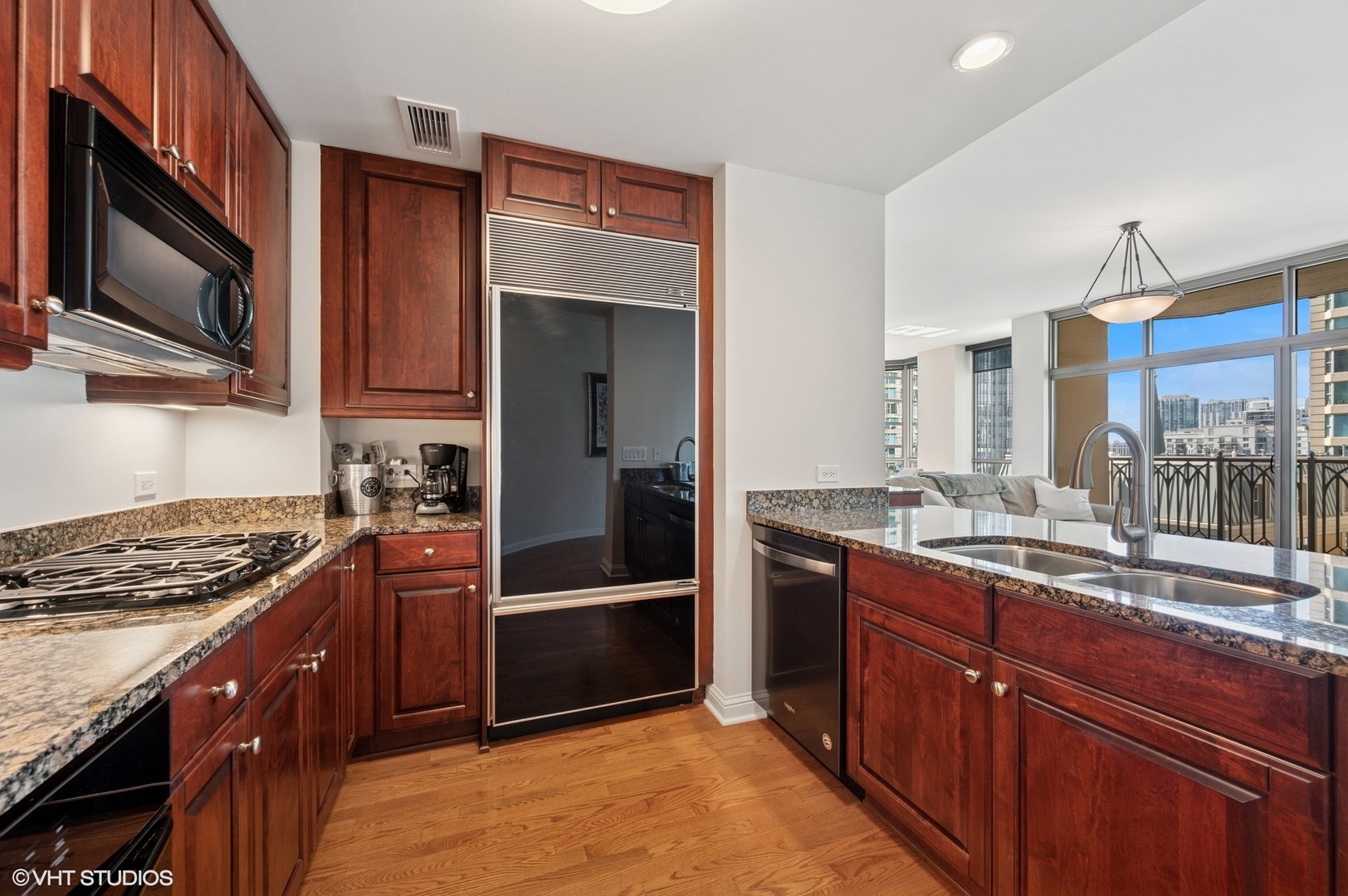 21 East Huron Street, Unit 1407 Chicago, IL 60611 - Photo 7 of 23 a kitchen with stainless steel appliances granite countertop a stove a sink and a microwave