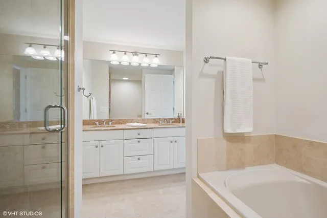 a bathroom with a tub sink and mirror