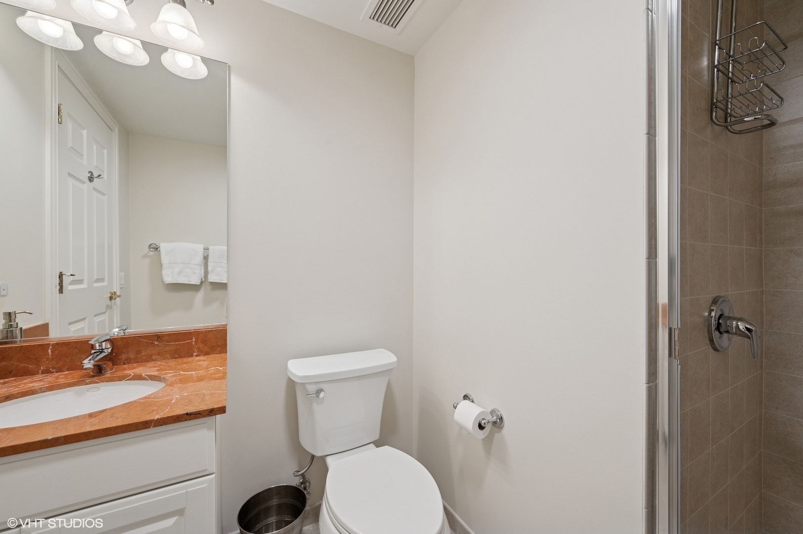 21 East Huron Street, Unit 1407 Chicago, IL 60611 - Photo 10 of 23 a bathroom with a toilet a sink and mirror
