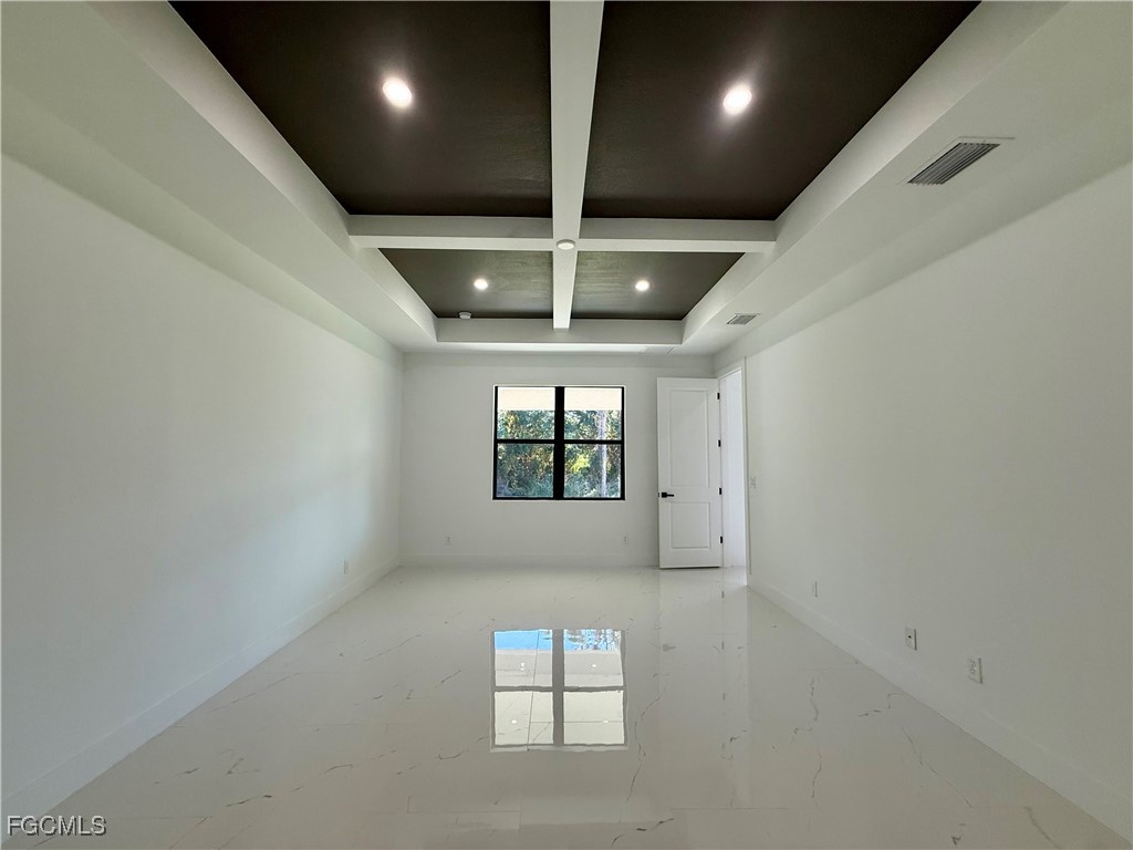 2909 10th Street West Lehigh Acres, FL 33971 - Photo 13 of 31 an empty room with windows and chandelier