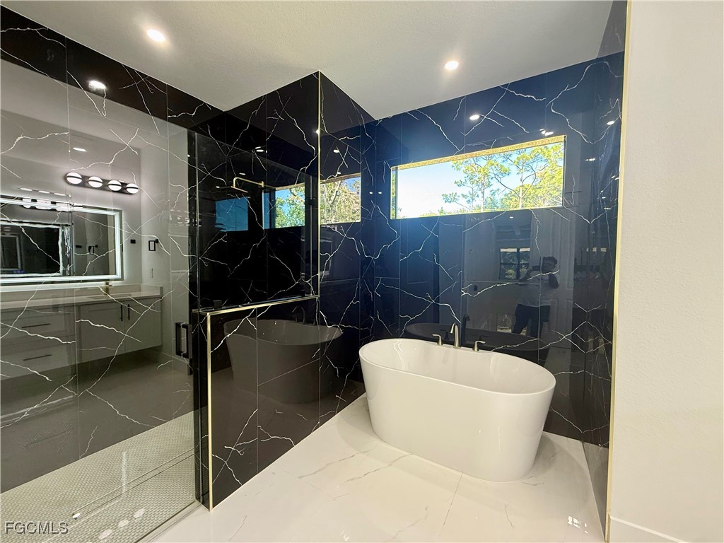 2909 10th Street West Lehigh Acres, FL 33971 - Photo 16 of 31 a bathroom with a bathtub and shower