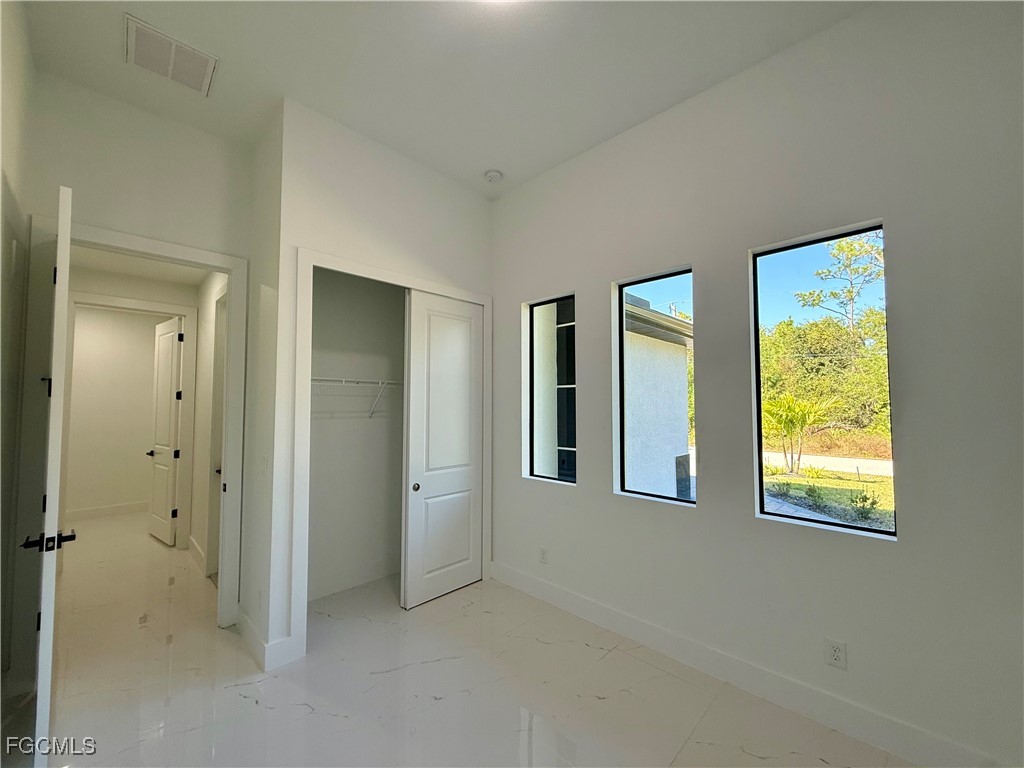 2909 10th Street West Lehigh Acres, FL 33971 - Photo 25 of 31 an empty room with windows and closet