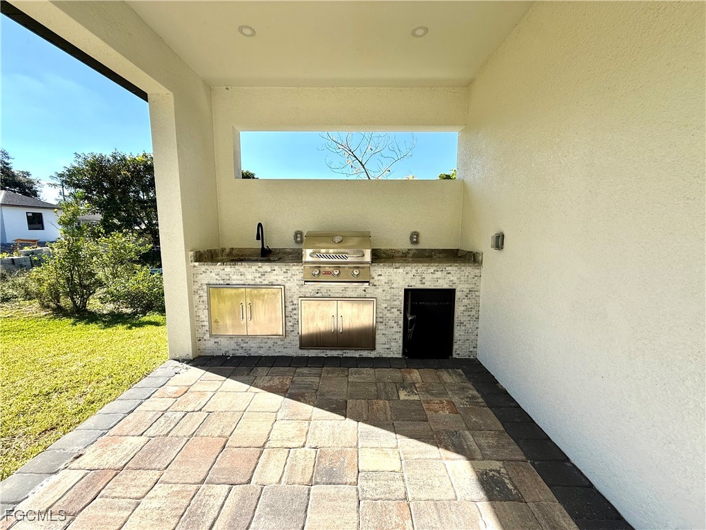 2909 10th Street West Lehigh Acres, FL 33971 - Photo 30 of 31 a view of kitchen with kitchen island a sink and a stove