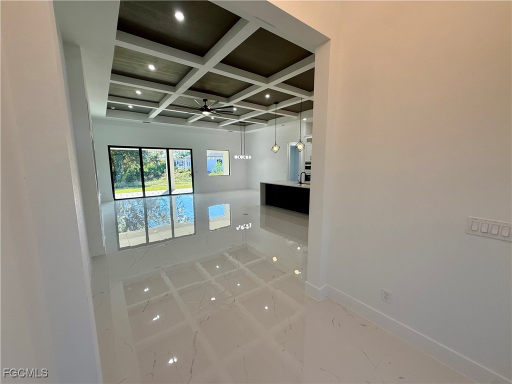2909 10th Street West Lehigh Acres, FL 33971 - Photo 5 of 31 a view of empty room with wooden floor and fan