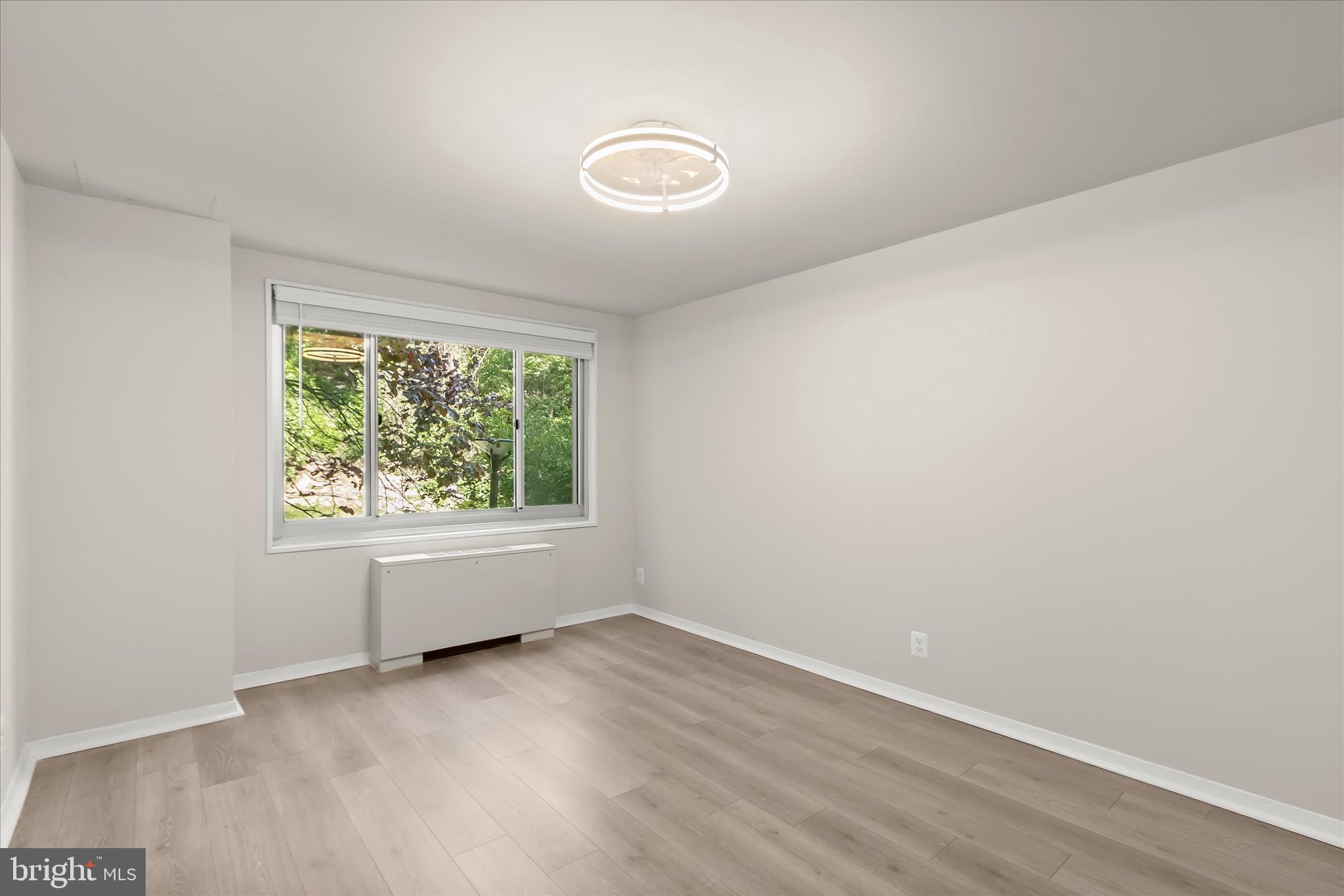 1900 Lyttonsville Road, Unit 216 Silver Spring, MD 20910 - Photo 16 of 36 an empty room with a window