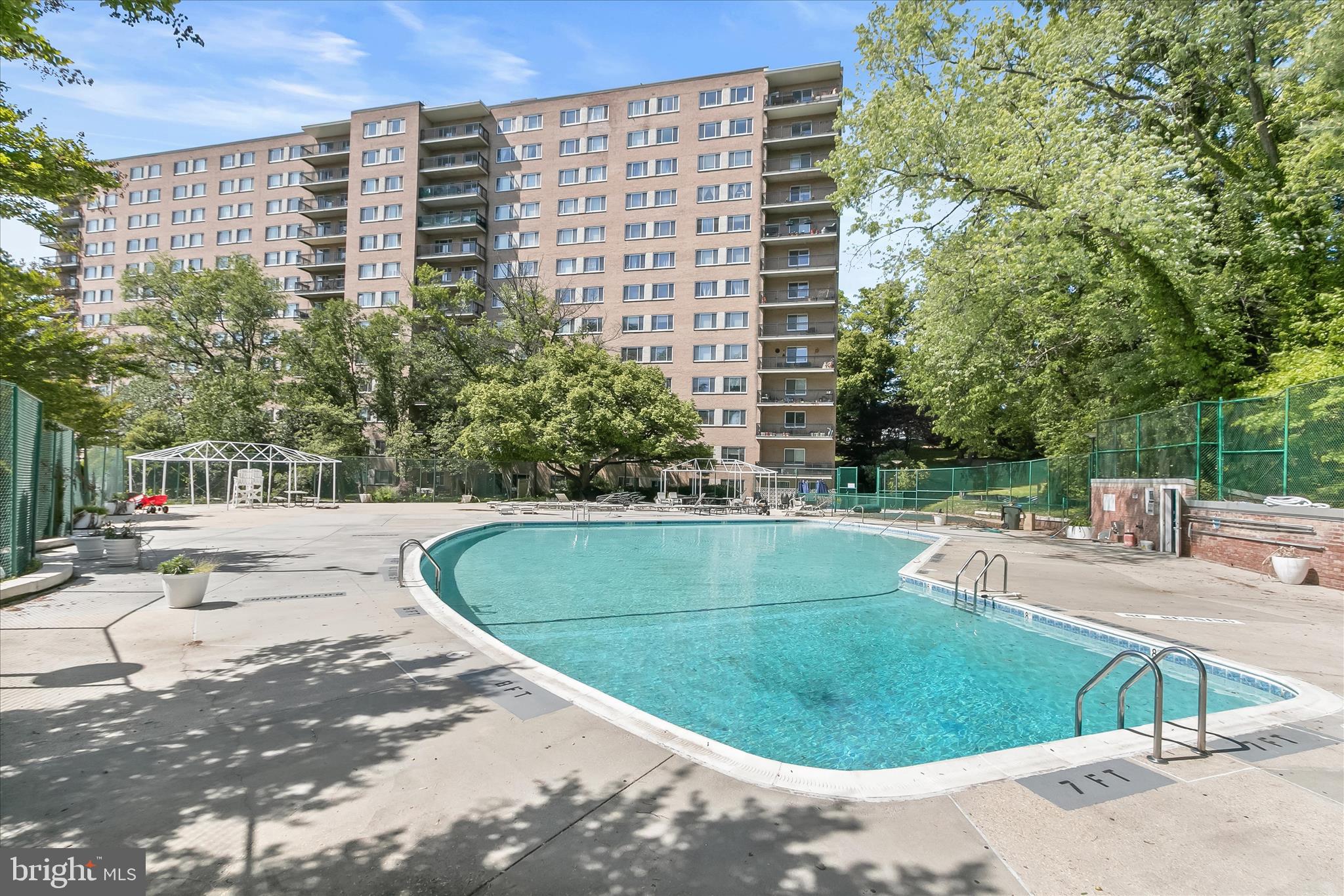 1900 Lyttonsville Road, Unit 216 Silver Spring, MD 20910 - Photo 23 of 36 a view of a swimming pool with a sitting space