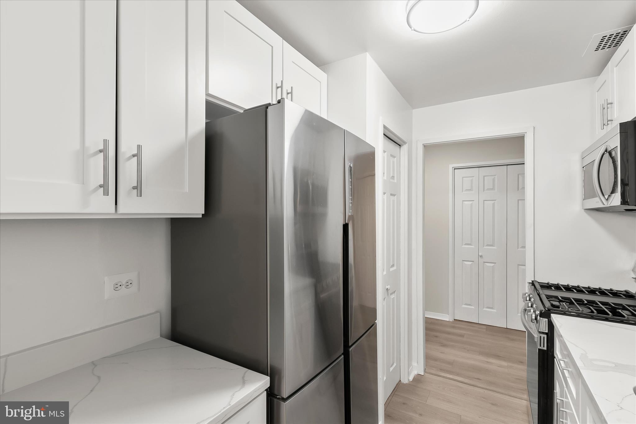 1900 Lyttonsville Road, Unit 216 Silver Spring, MD 20910 - Photo 4 of 36 a kitchen with stainless steel appliances a refrigerator and cabinets