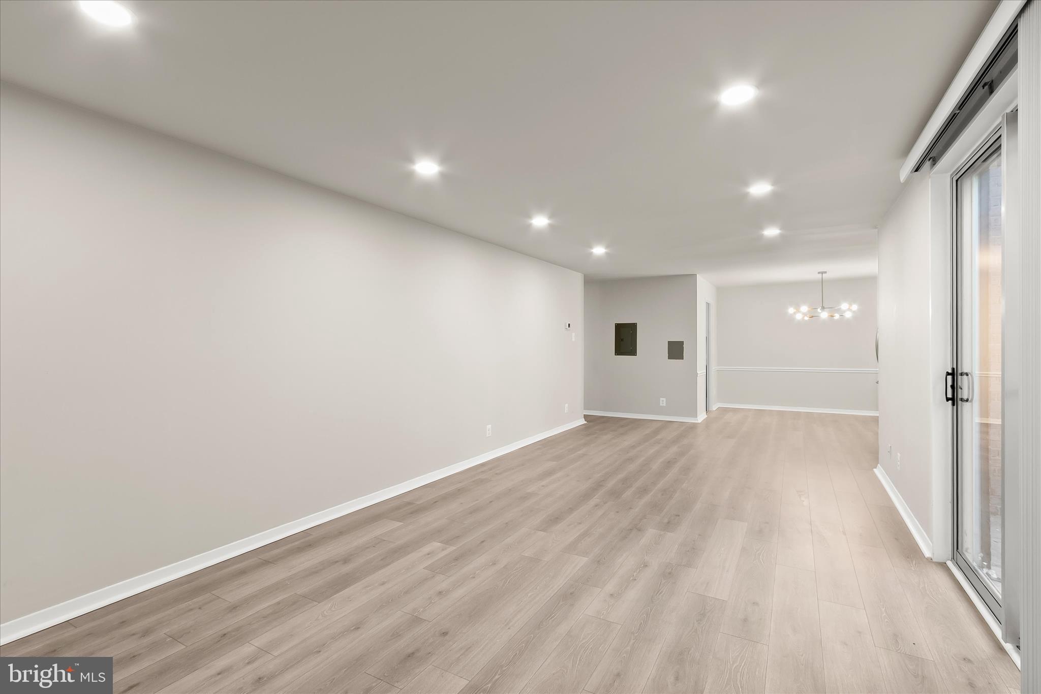 1900 Lyttonsville Road, Unit 216 Silver Spring, MD 20910 - Photo 7 of 36 an empty room with wooden floor and windows