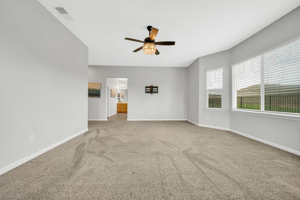 20300 Panoz Road Patterson, CA 95363 - Photo 15 of 61 a view of a livingroom with a ceiling fan and window