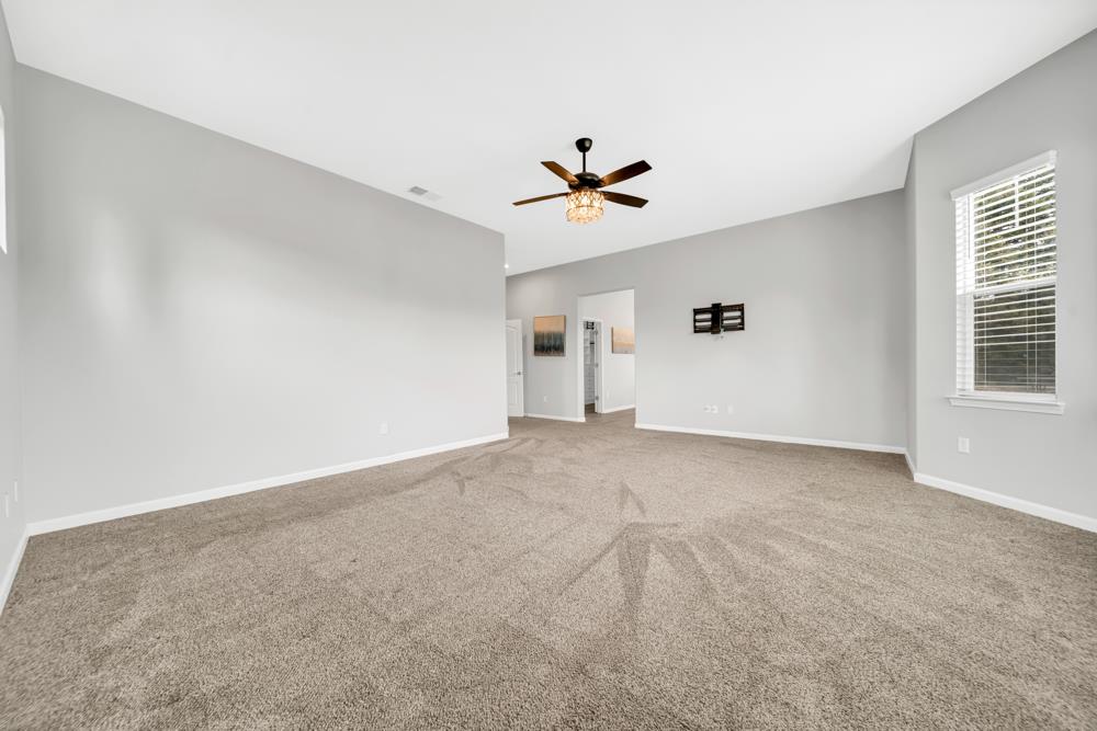 20300 Panoz Road Patterson, CA 95363 - Photo 16 of 61 a view of a livingroom with a ceiling fan and window