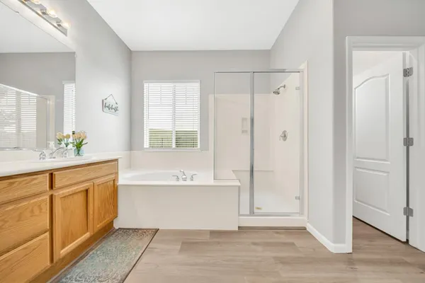 a spacious bathroom with a double vanity sink toilet and shower