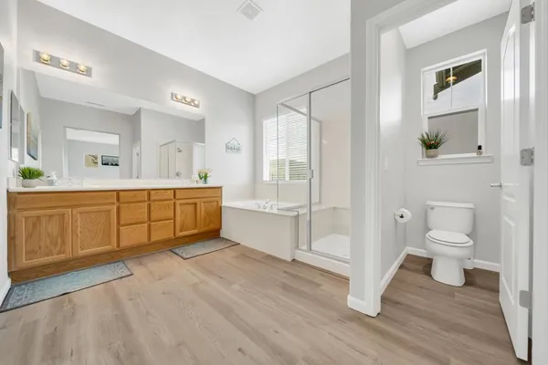 a spacious bathroom with a toilet a sink and a bathtub