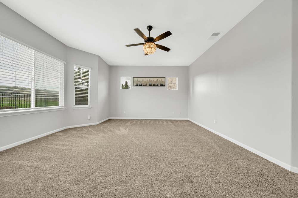 20300 Panoz Road Patterson, CA 95363 - Photo 21 of 61 an empty room with windows and ceiling fan