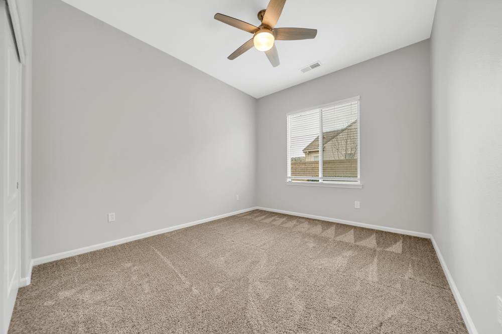 20300 Panoz Road Patterson, CA 95363 - Photo 23 of 61 an empty room with window and ceiling fan