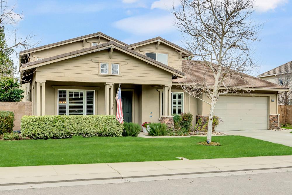 20300 Panoz Road Patterson, CA 95363 - Photo 3 of 61 a front view of a house with a garden and plants