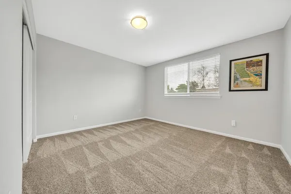 a view of a livingroom with furniture window and wooden floor