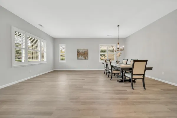a view of a house with pool and a yard