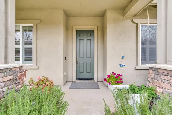 a kitchen with stainless steel appliances granite countertop a refrigerator oven a sink dishwasher and white cabinets with wooden floor