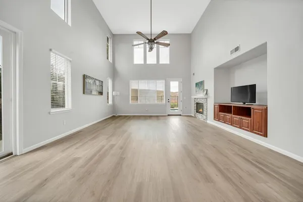 an empty room with furniture and a fireplace