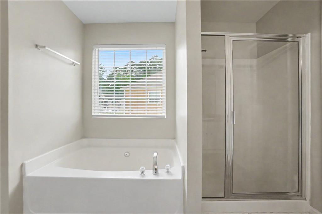 375 Walton View Fairburn, GA 30213 - Photo 27 of 38 a bathroom with a bathtub and a shower