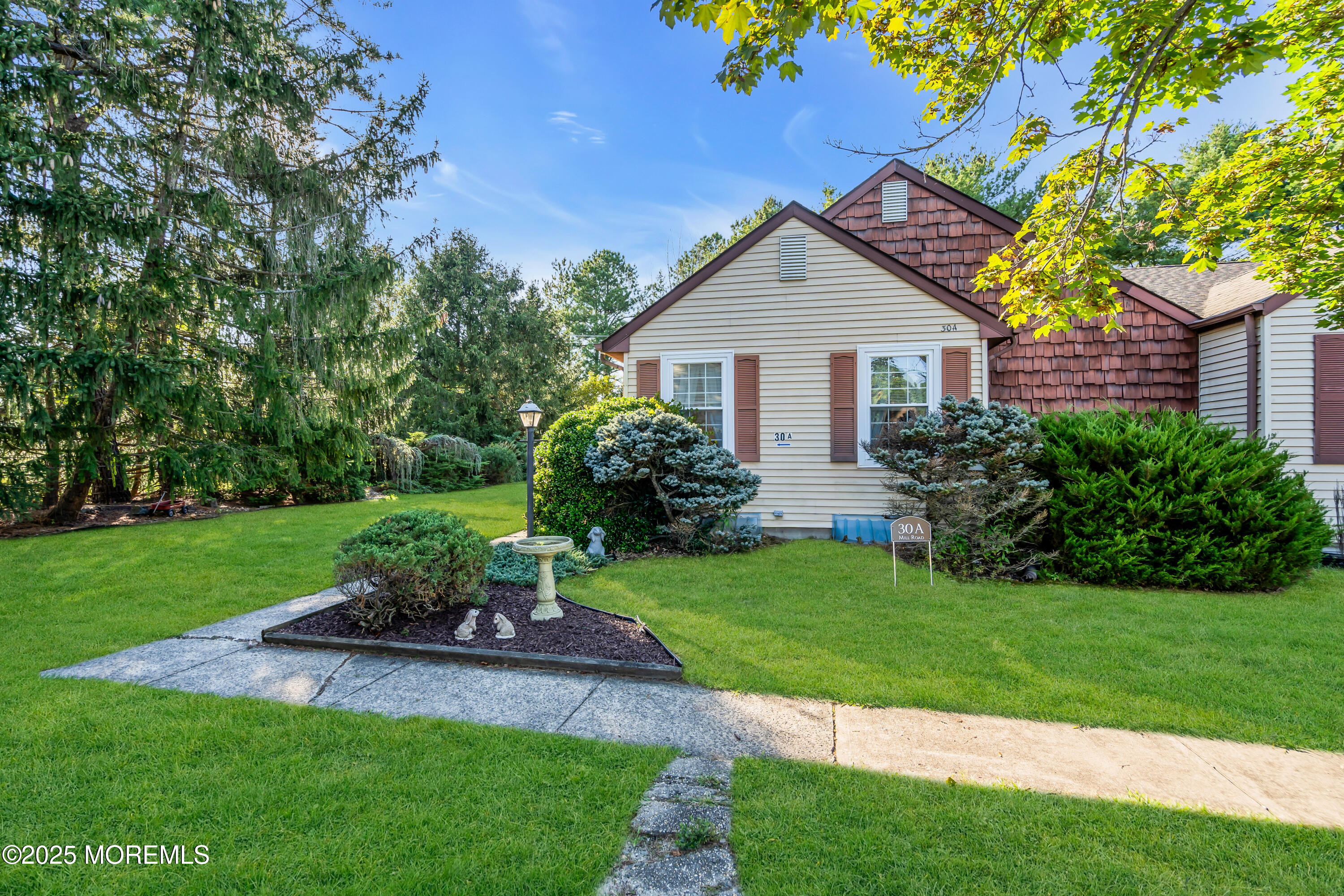 a view of a house with a yard and a garden
