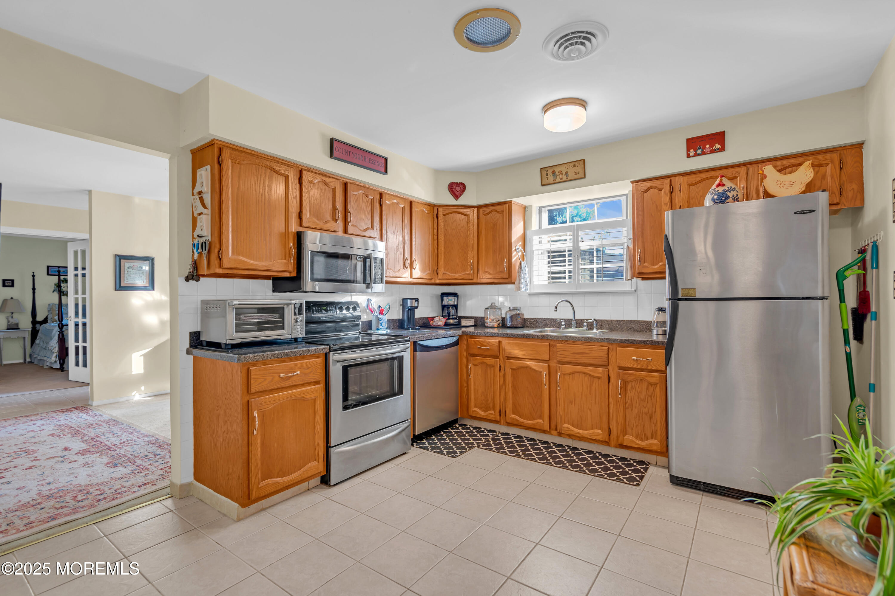 30 A Mill Road, Unit 64 Whiting, NJ 08759 - Photo 29 of 46 a kitchen with granite countertop a refrigerator and a stove top oven