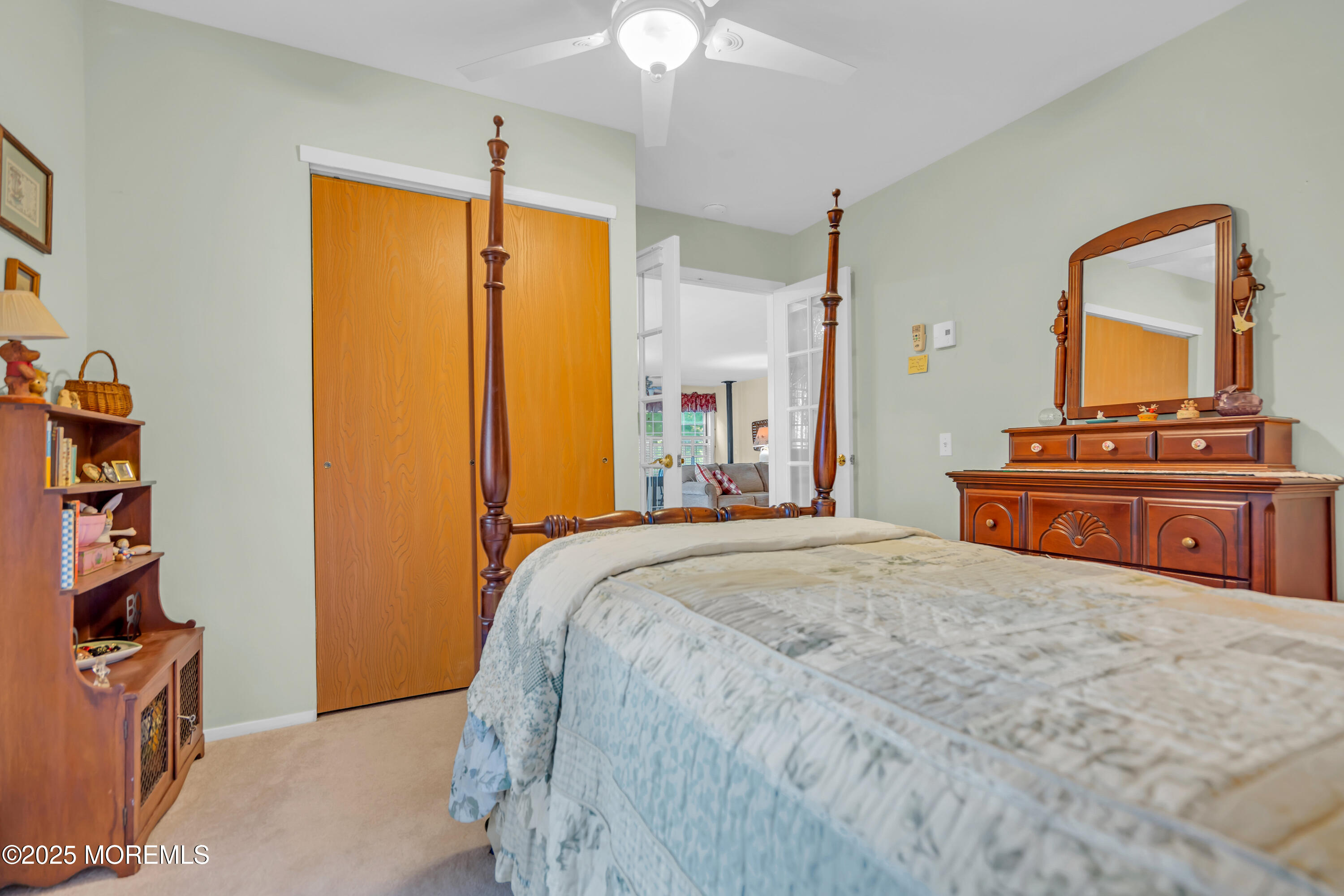 30 A Mill Road, Unit 64 Whiting, NJ 08759 - Photo 34 of 46 a bedroom with a bed and a flat tv screen on dresser