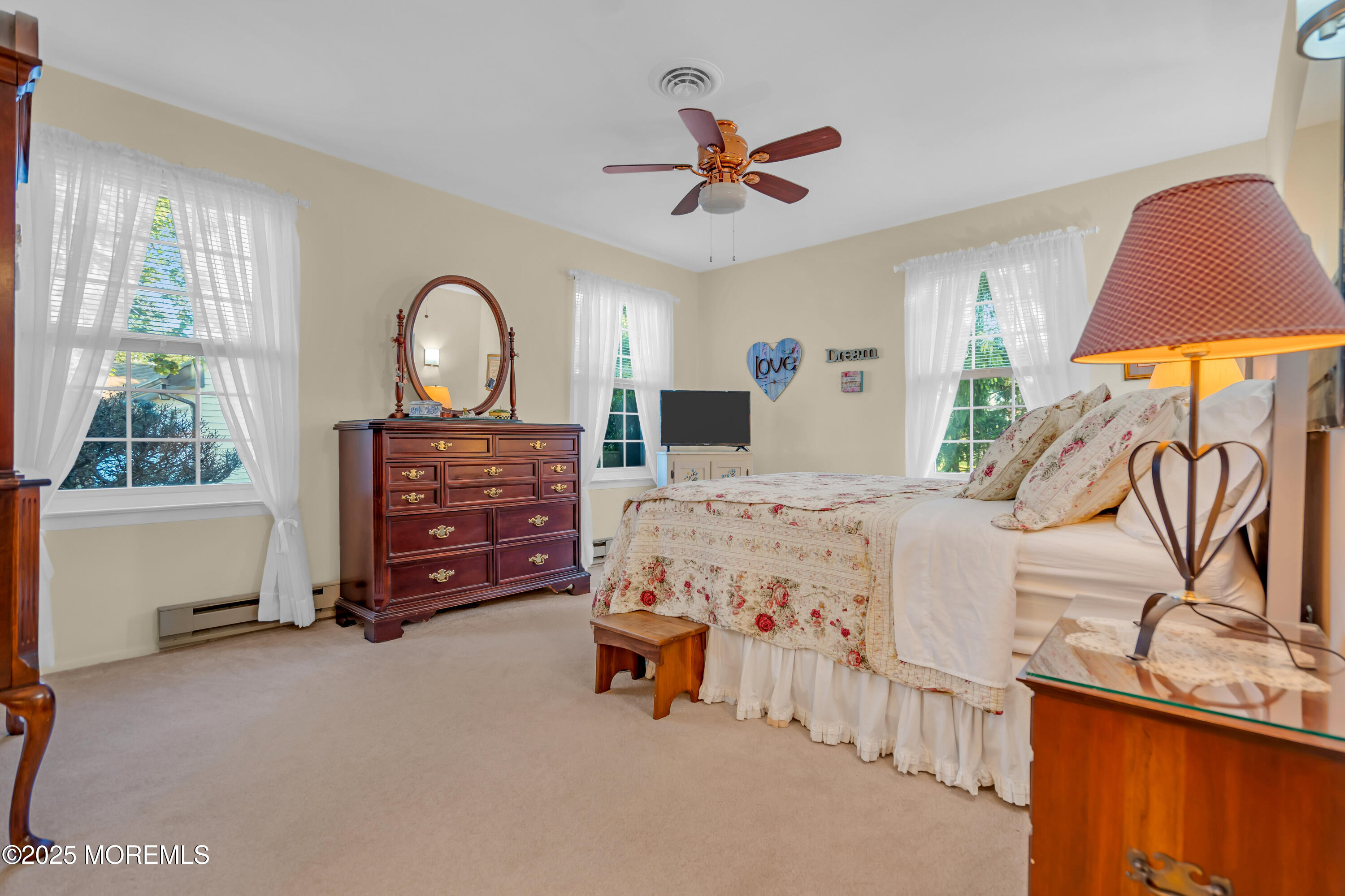 30 A Mill Road, Unit 64 Whiting, NJ 08759 - Photo 37 of 46 a bedroom with a bed and a chandelier