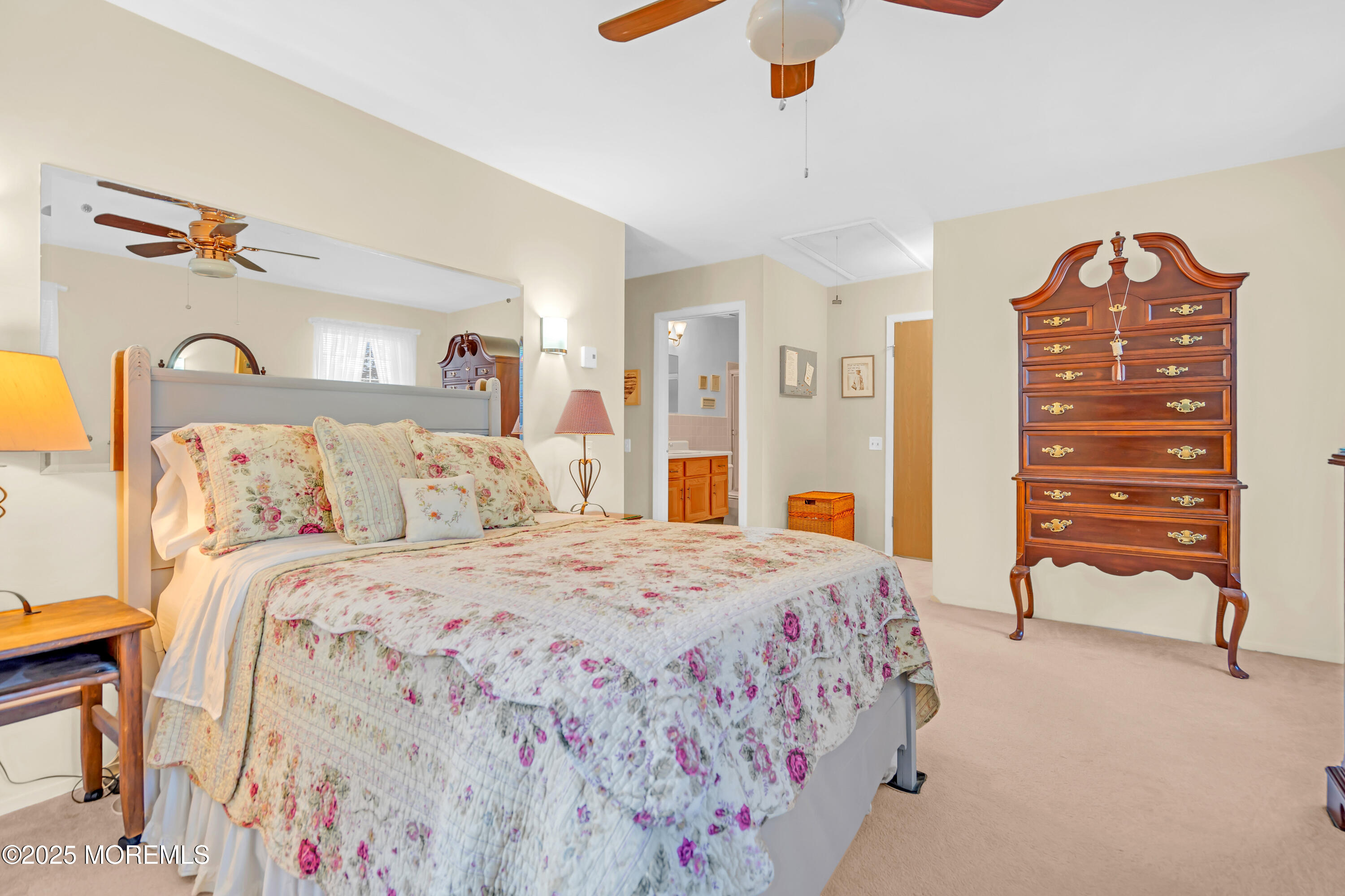 30 A Mill Road, Unit 64 Whiting, NJ 08759 - Photo 38 of 46 a bedroom with a bed and a chandelier