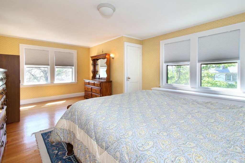 144 Lovell Road Watertown, MA 02472 - Photo 14 of 25 a spacious bedroom with a large bed and a large window