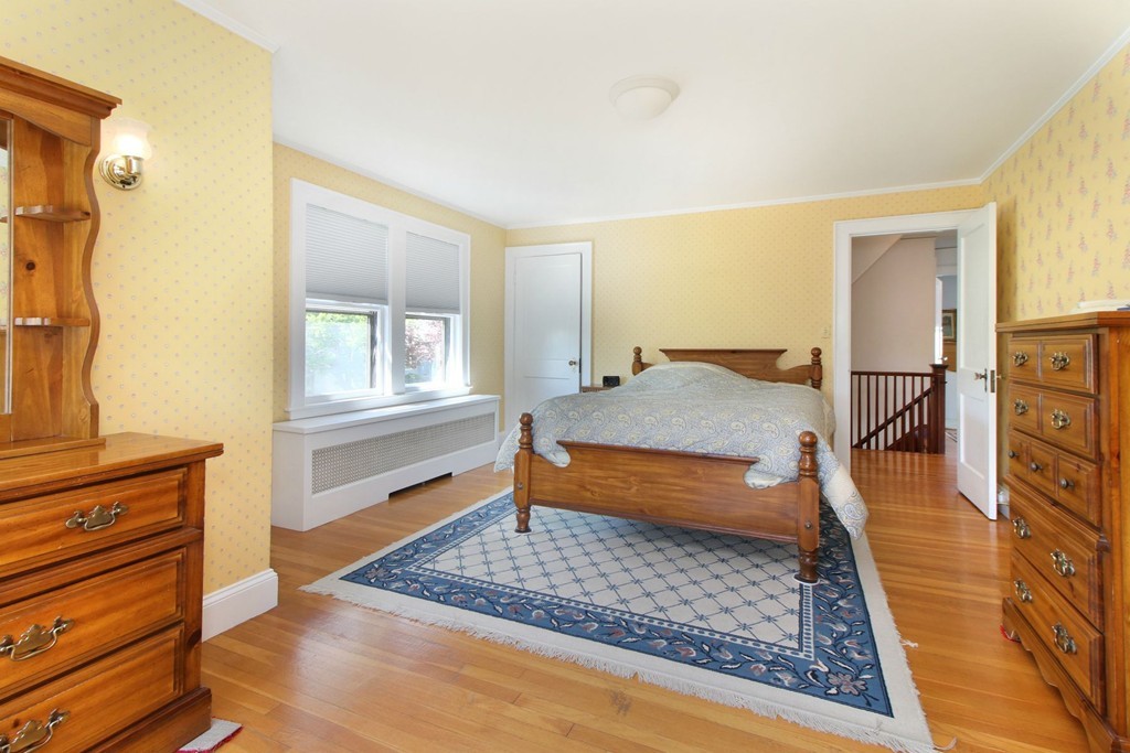 144 Lovell Road Watertown, MA 02472 - Photo 15 of 25 a bedroom with a bed and wooden floor