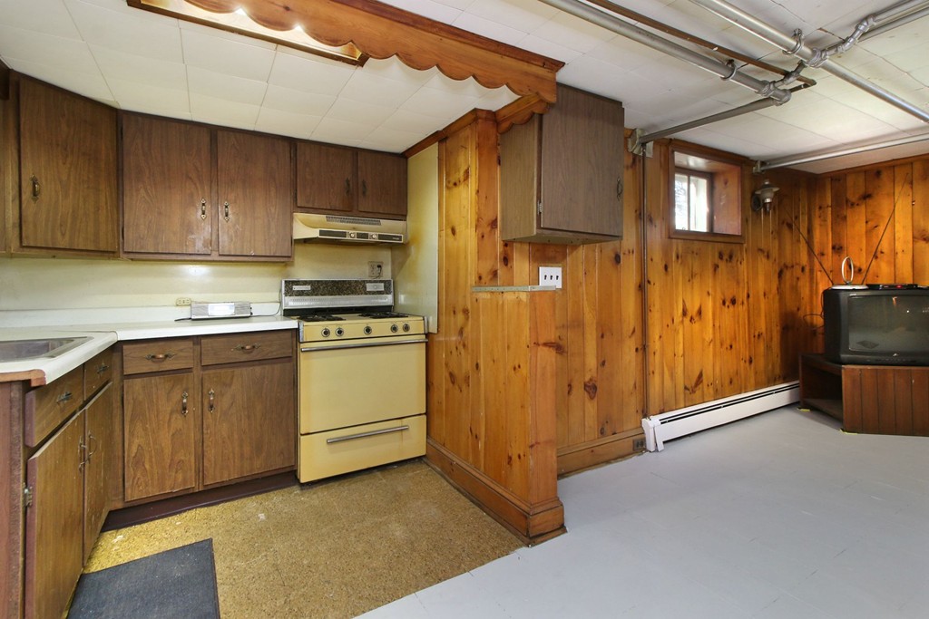 144 Lovell Road Watertown, MA 02472 - Photo 22 of 25 a kitchen with white cabinets and stainless steel appliances